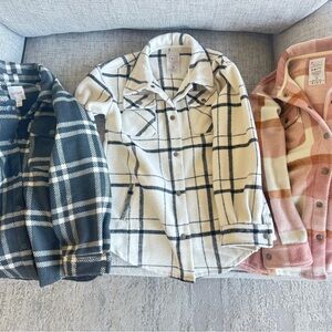 Trio of Plaid Snap Flannel Shackets in Black, White, and Pink